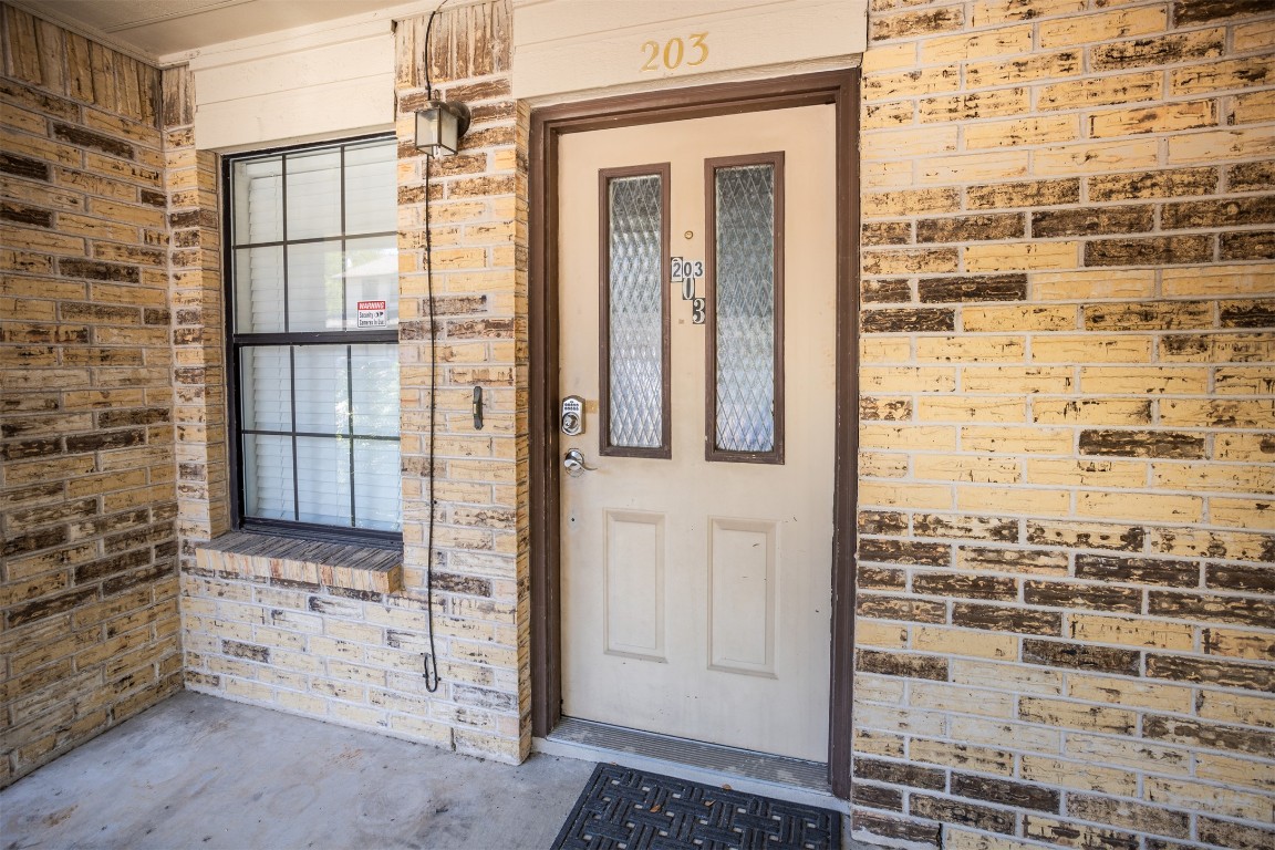 7800 Northcrest Boulevard, Unit 203 Austin, TX 78752 - Photo 5 of 19 front view of a glass door