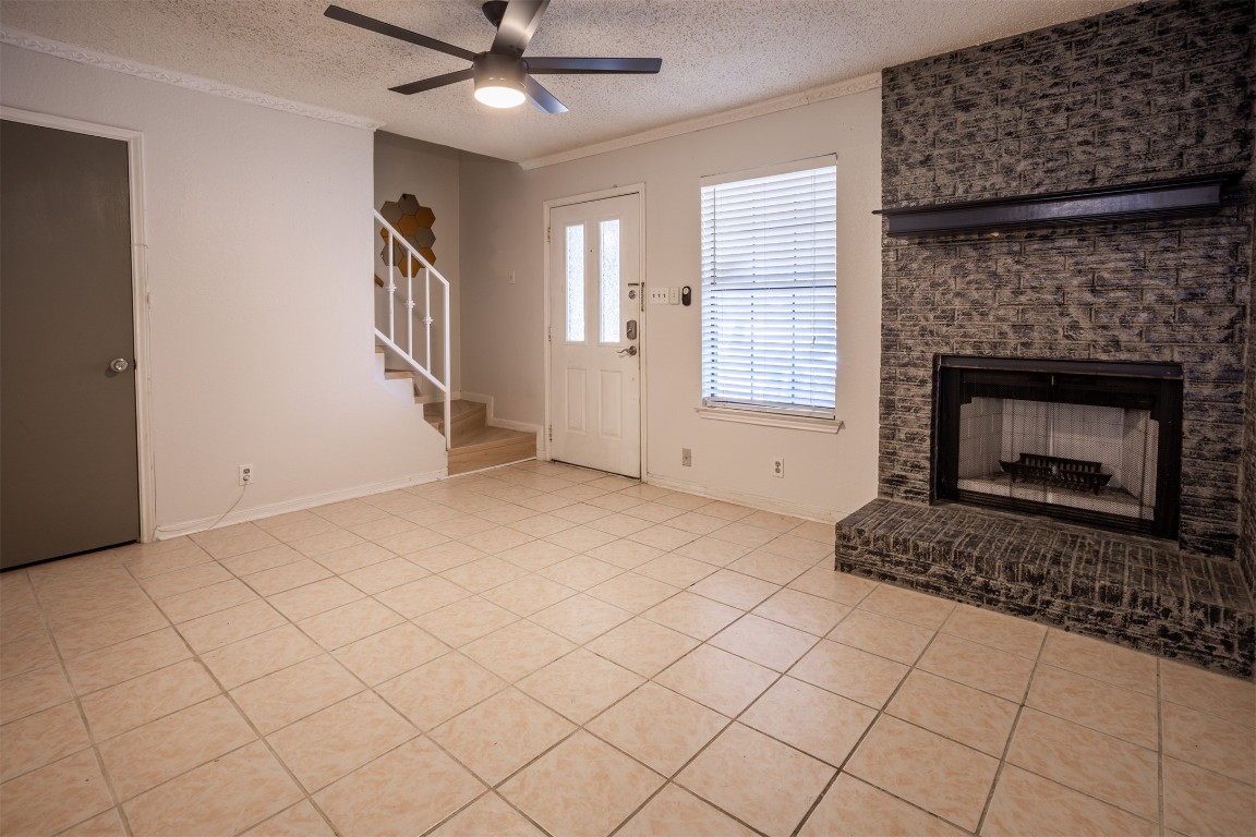 7800 Northcrest Boulevard, Unit 203 Austin, TX 78752 - Photo 7 of 19 a view of an empty room with window and fire place