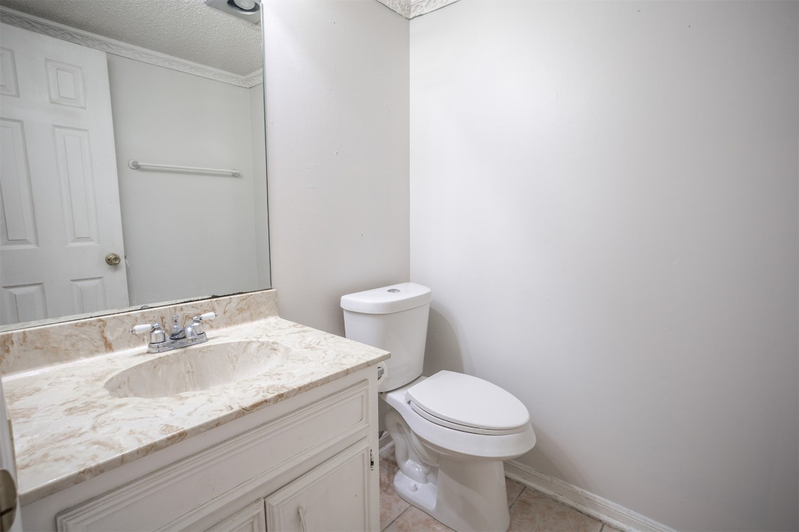 7800 Northcrest Boulevard, Unit 203 Austin, TX 78752 - Photo 8 of 19 a bathroom with a granite countertop toilet and a sink