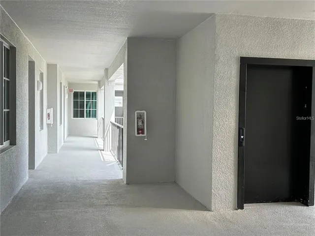 a view of a kitchen with a sink and a refrigerator