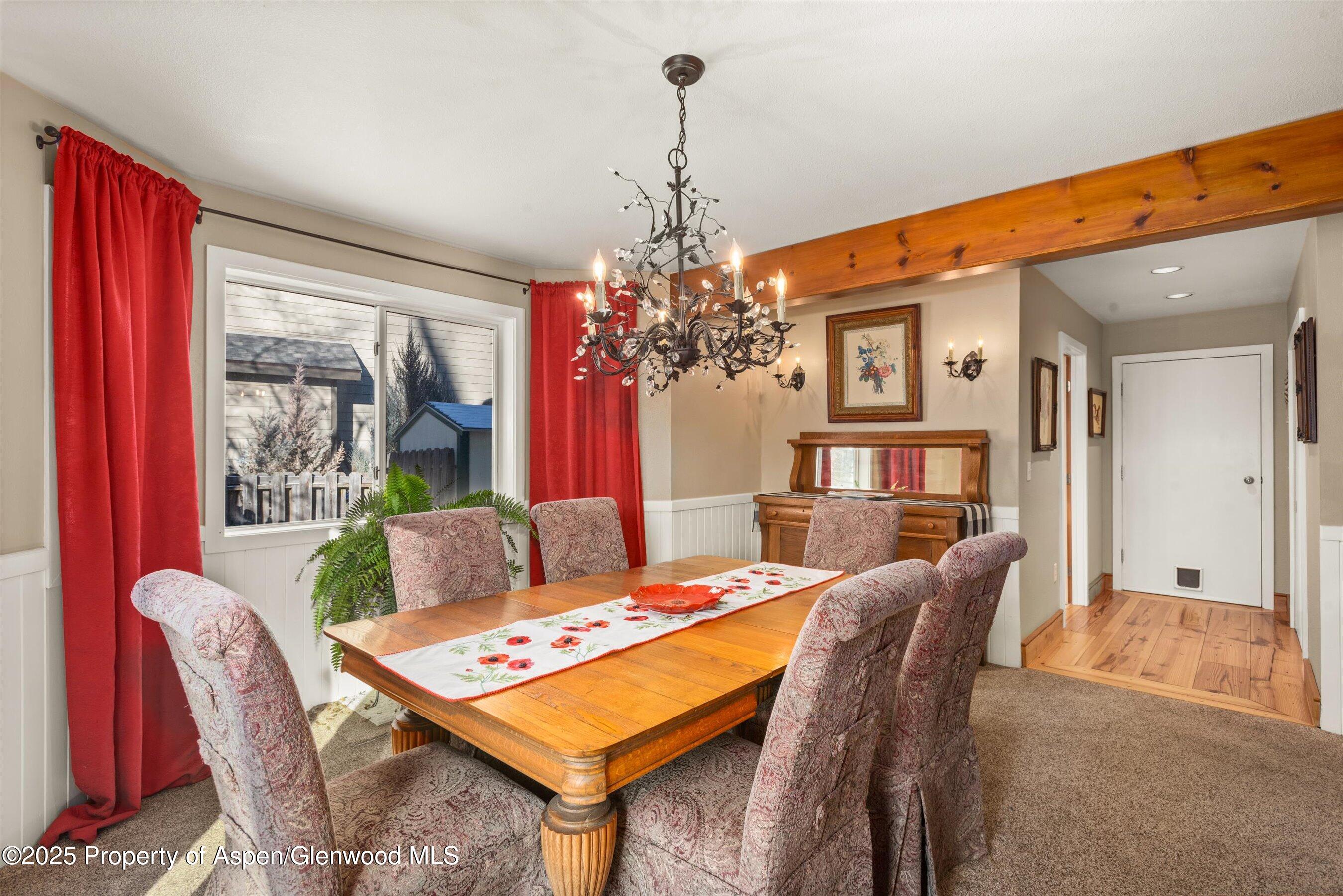 93 Quail Run Carbondale, CO 81623 - Photo 16 of 36 a dining room with furniture a chandelier and window