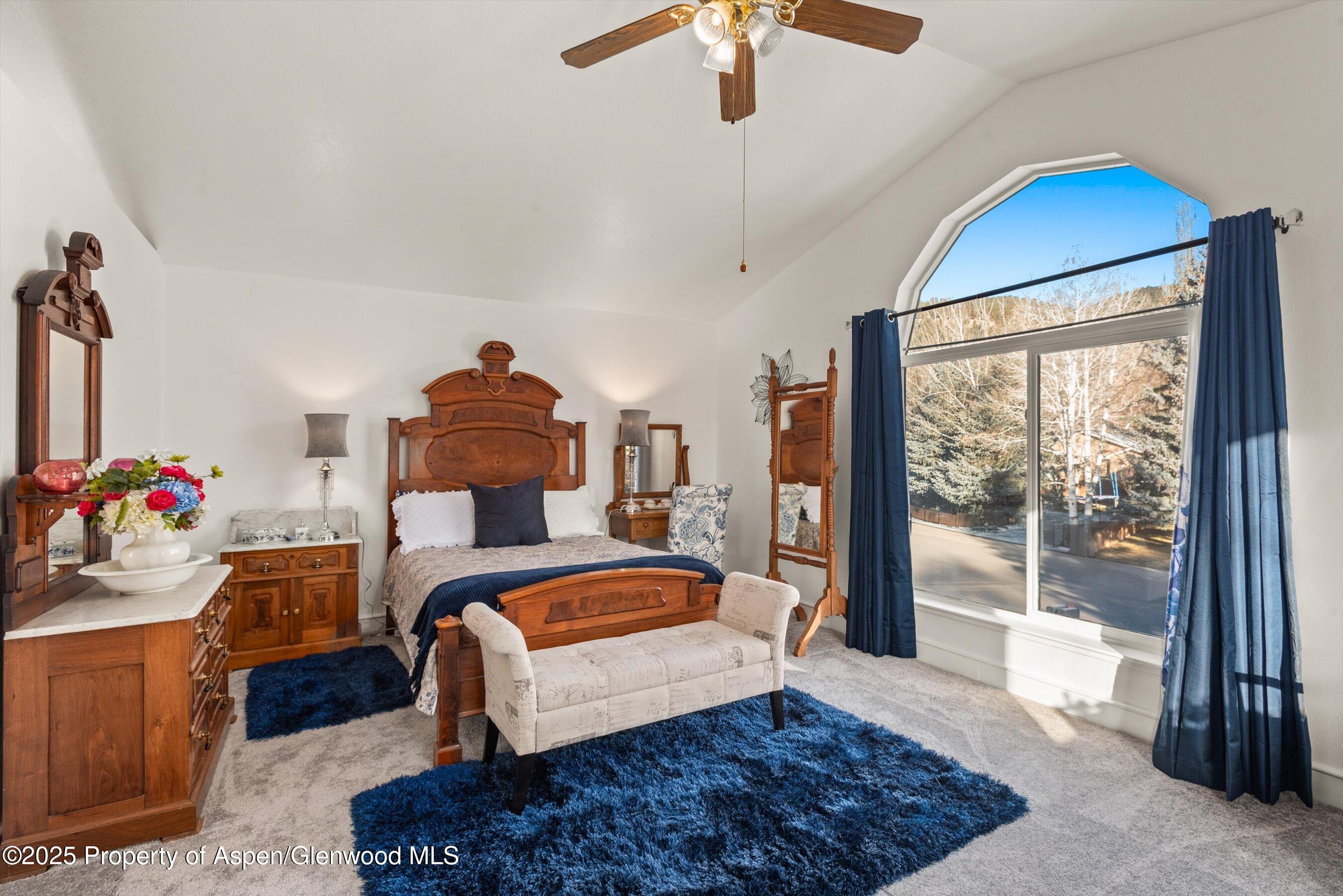 93 Quail Run Carbondale, CO 81623 - Photo 17 of 36 a bedroom with a bed and a chandelier