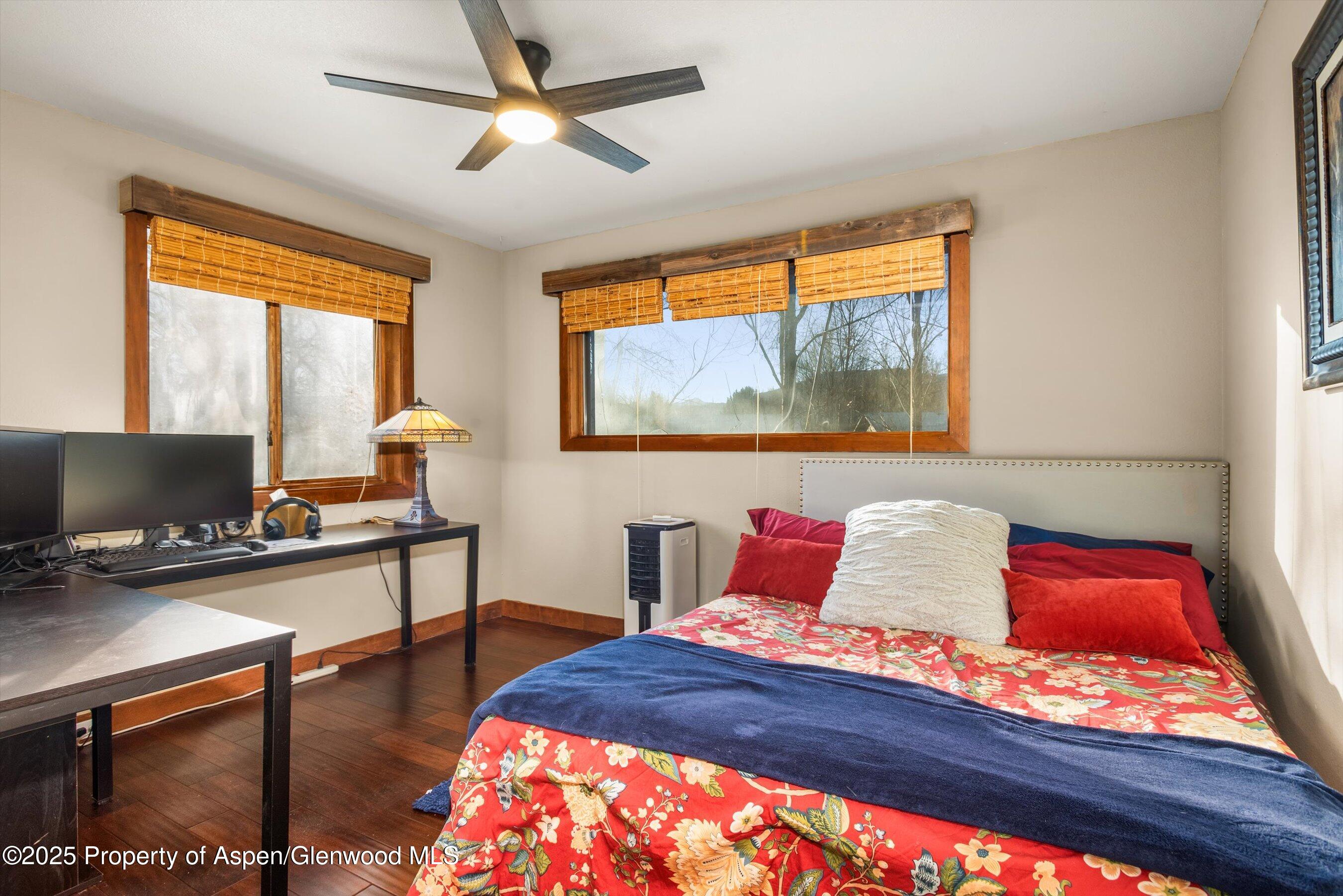 93 Quail Run Carbondale, CO 81623 - Photo 21 of 36 a bedroom with a bed and wooden floor