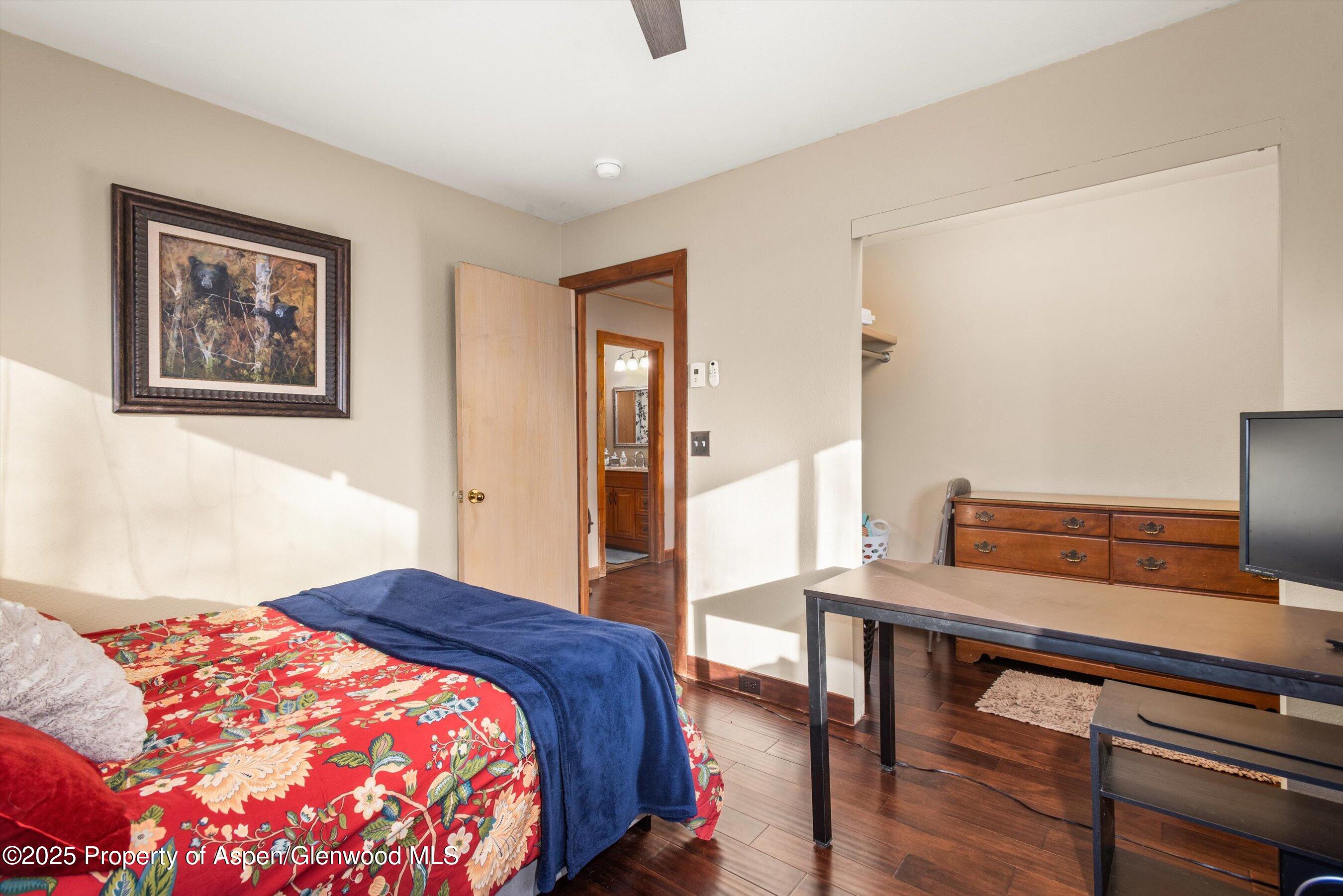 93 Quail Run Carbondale, CO 81623 - Photo 22 of 36 a bedroom with a bed and wooden floor