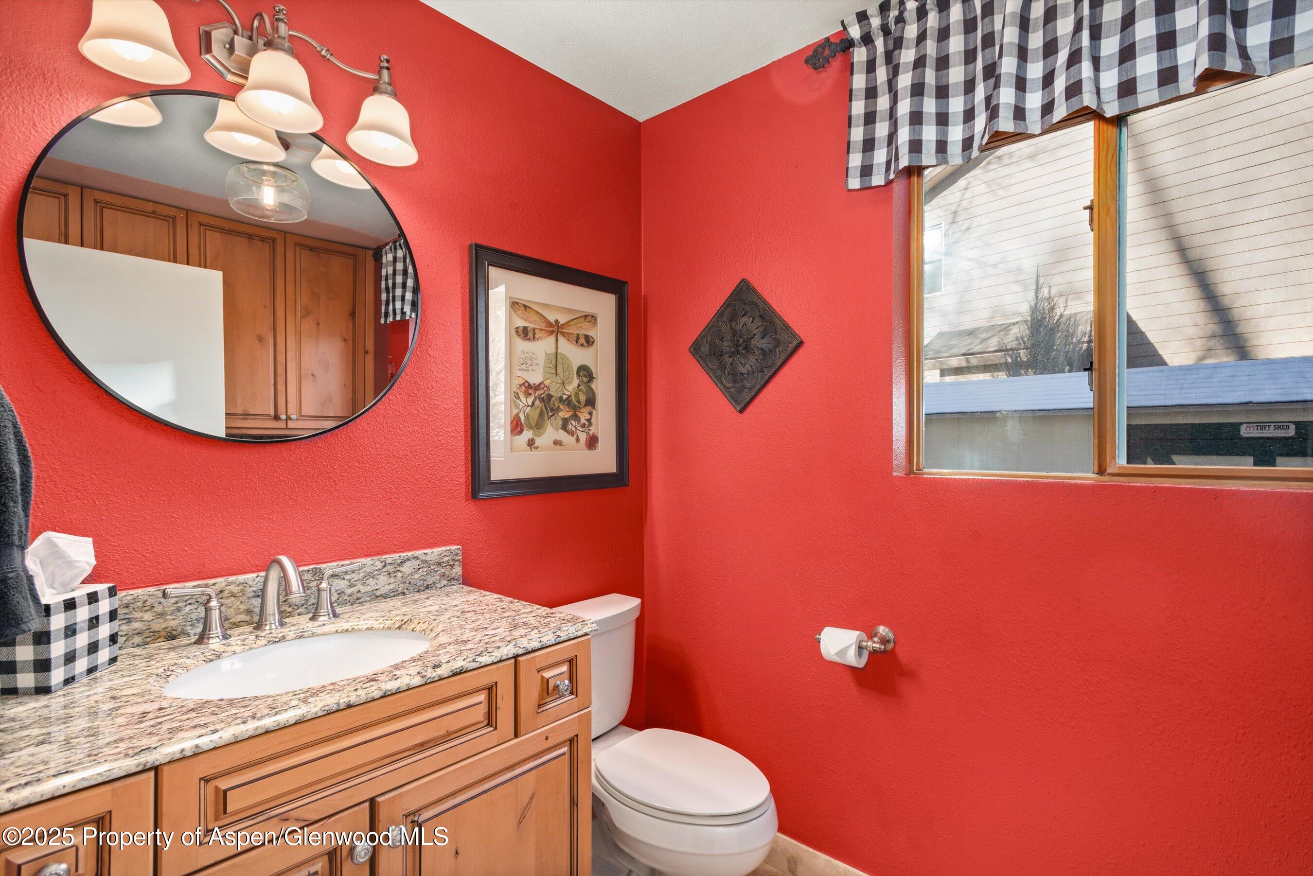 93 Quail Run Carbondale, CO 81623 - Photo 25 of 36 a bathroom with a granite countertop toilet sink and mirror