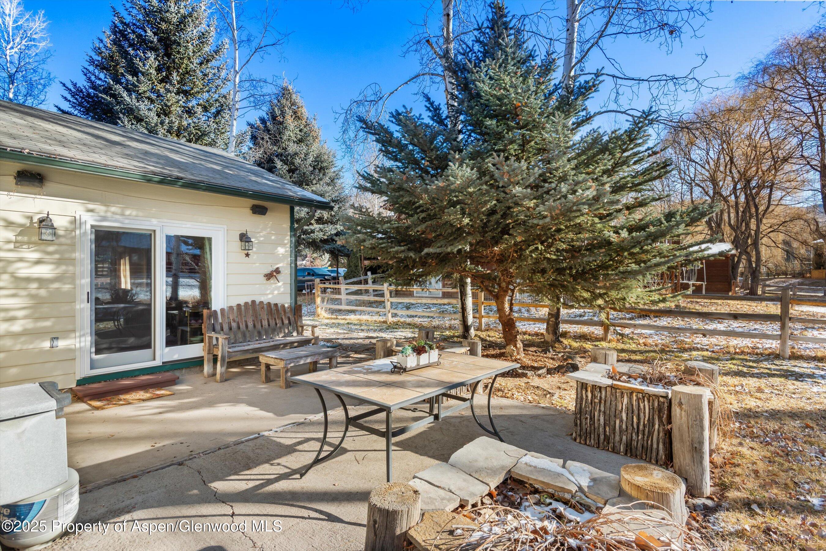 93 Quail Run Carbondale, CO 81623 - Photo 32 of 36 a backyard of a house with barbeque oven table and chairs
