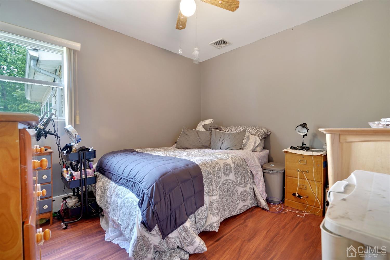 27 Raleigh Road Edison, NJ 08817 - Photo 12 of 29 a bedroom with a bed and wooden floor