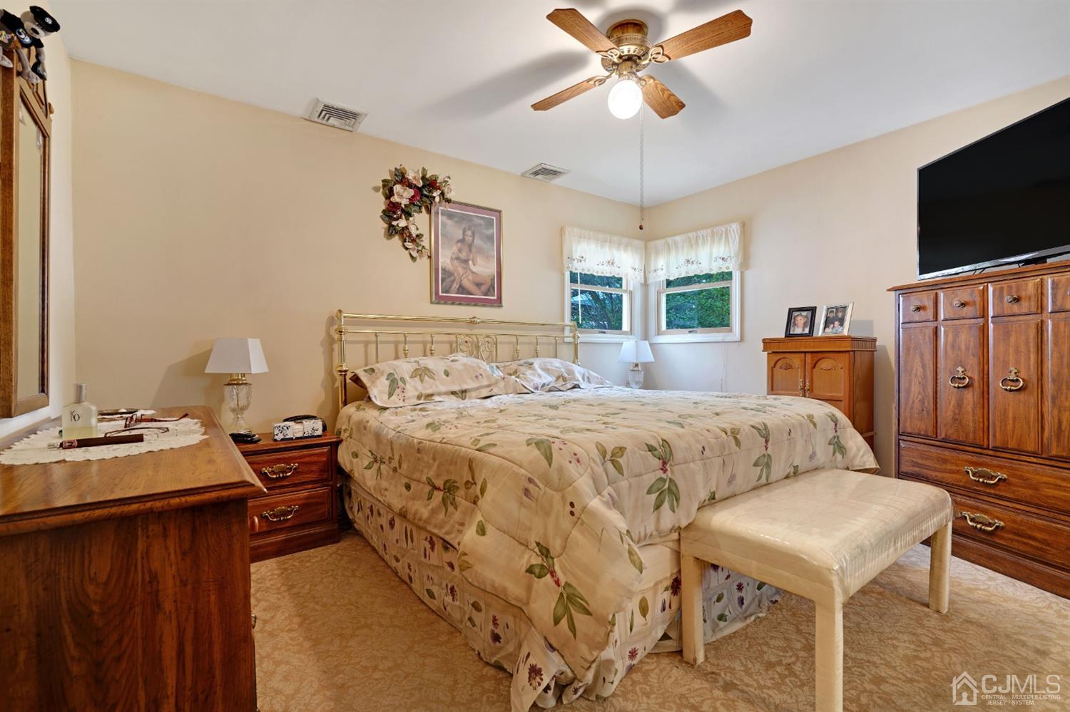 27 Raleigh Road Edison, NJ 08817 - Photo 14 of 29 a bedroom with a bed and a flat screen tv