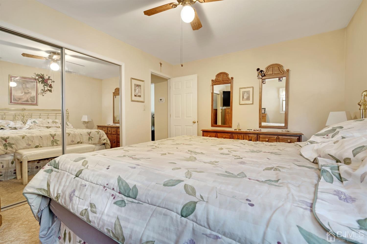 27 Raleigh Road Edison, NJ 08817 - Photo 15 of 29 a bedroom with a bed and a chandelier