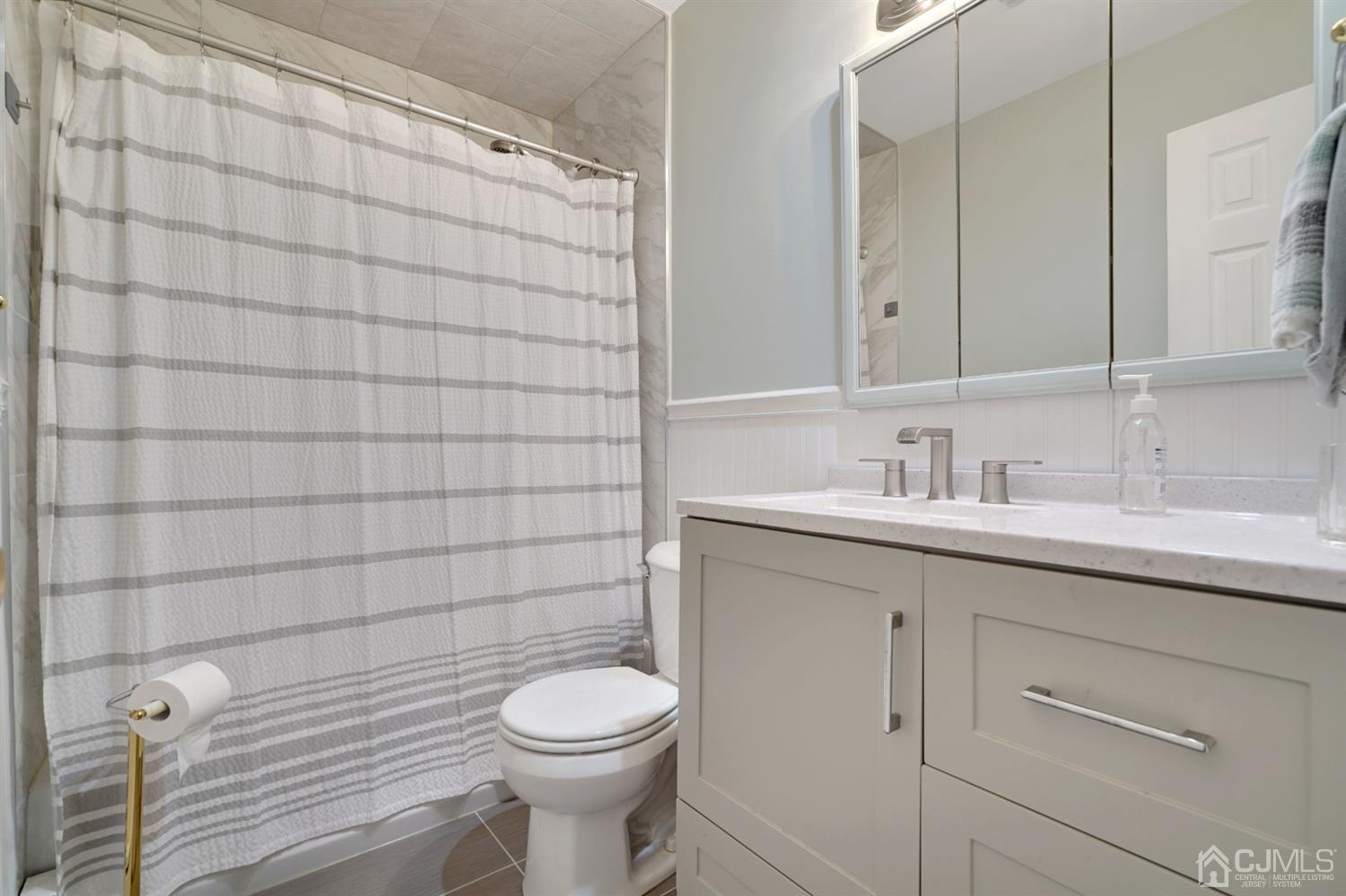 27 Raleigh Road Edison, NJ 08817 - Photo 17 of 29 a bathroom with a sink a toilet and shower