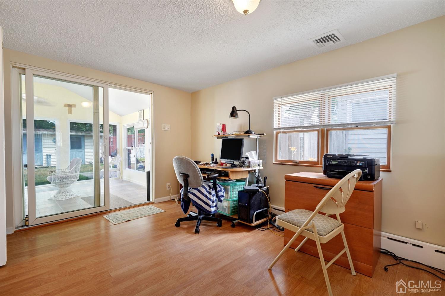27 Raleigh Road Edison, NJ 08817 - Photo 18 of 29 a workspace with wooden floor and a window