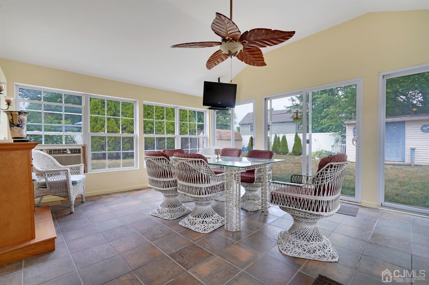 27 Raleigh Road Edison, NJ 08817 - Photo 19 of 29 a dining room with furniture water view and a floor to ceiling window