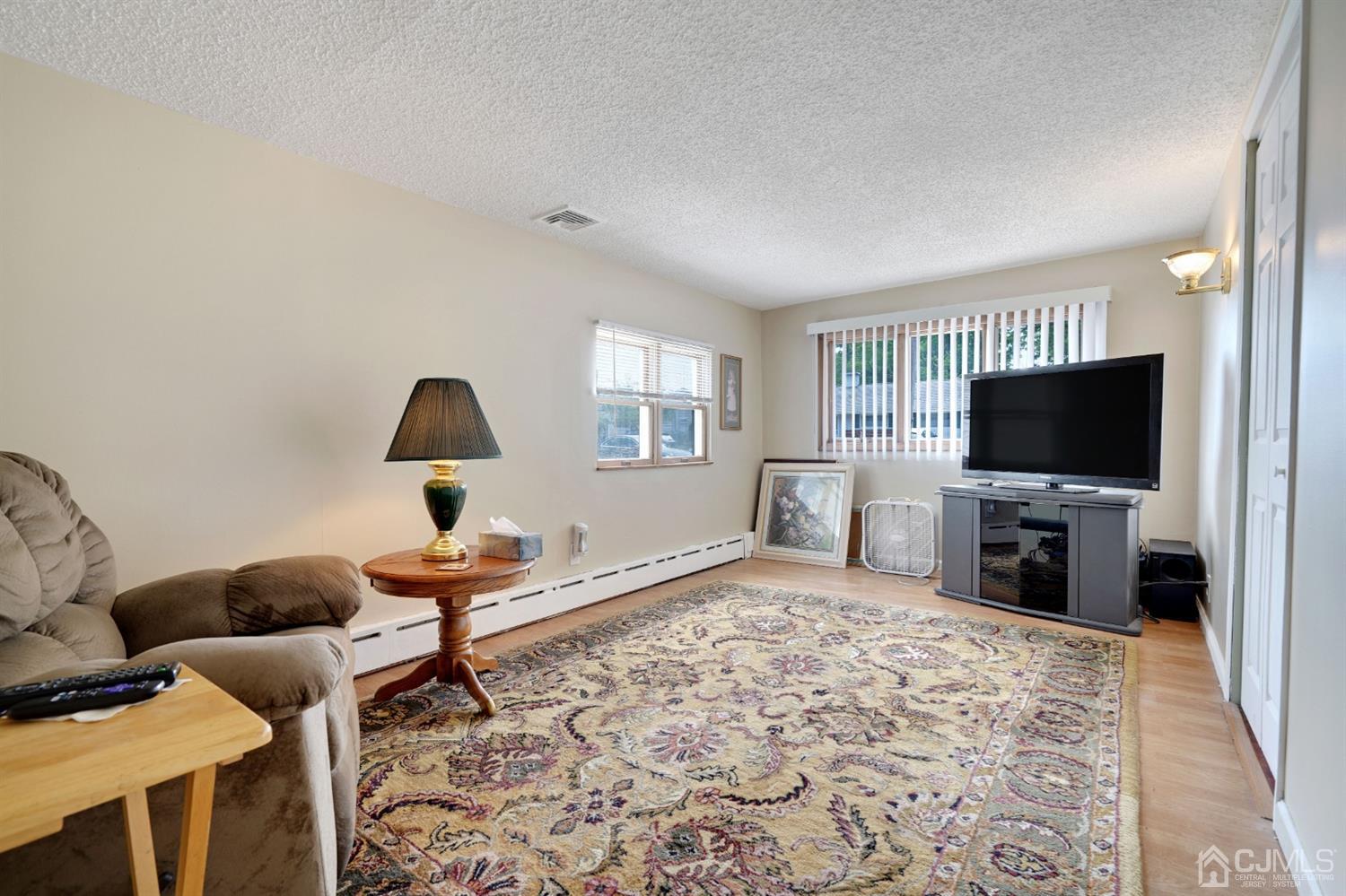 27 Raleigh Road Edison, NJ 08817 - Photo 10 of 29 a living room with furniture and a flat screen tv