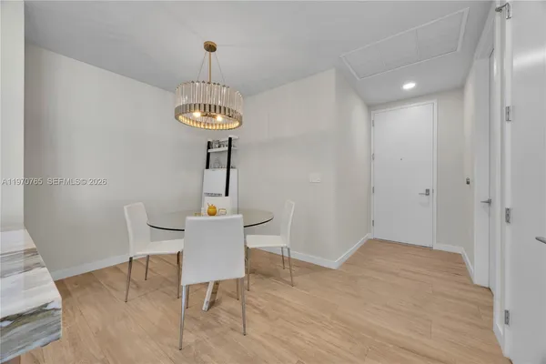 a dining room with a table and chairs