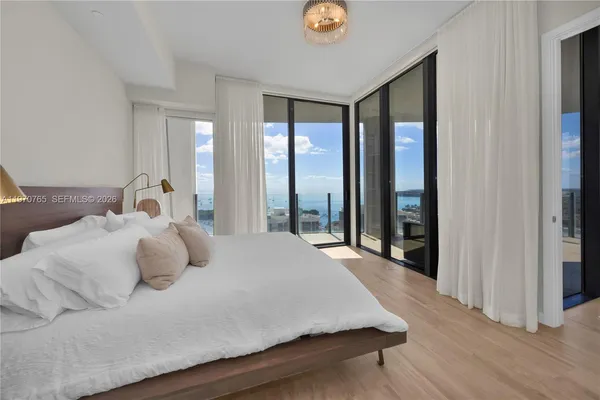 a bedroom with a bed and a large window