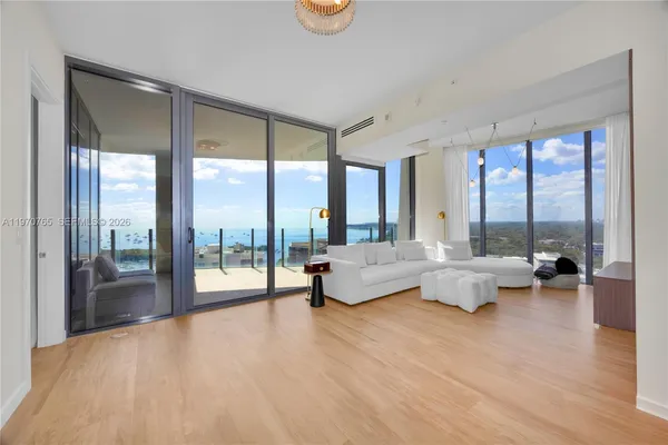 a living room with furniture and a large window with outer view