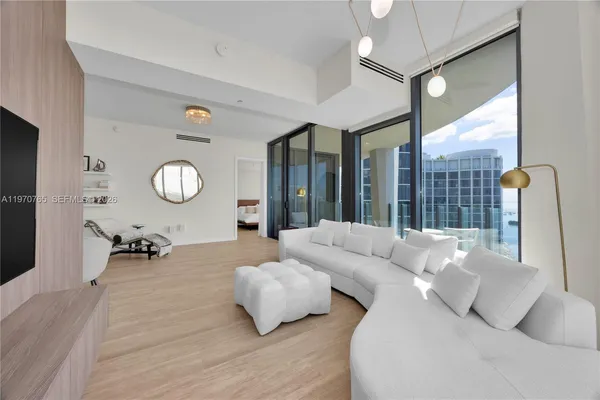 a living room with furniture and a large window