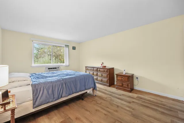 a bedroom with a bed and dresser