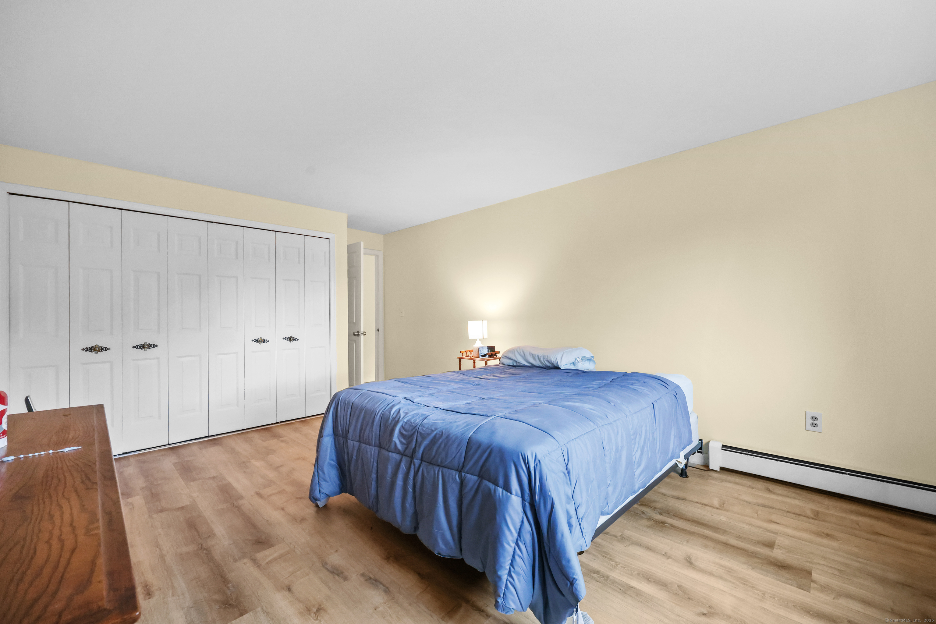 60 Rambling Brook Lane, Unit C8 Glastonbury, CT 06033 - Photo 15 of 20 a bedroom with a bed and wooden floor