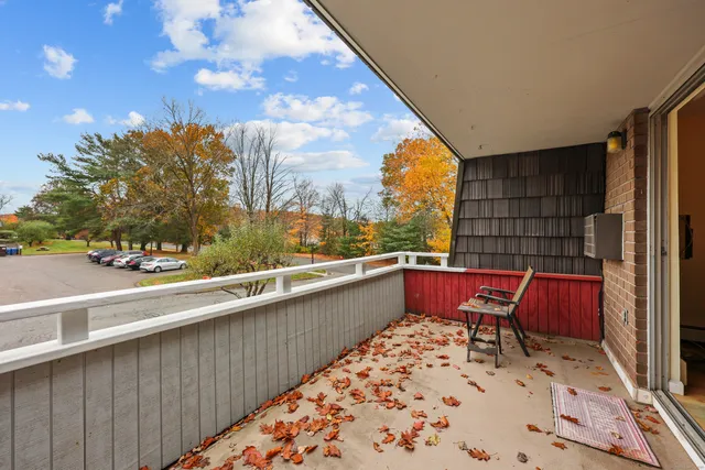 a roof deck with table and chairs