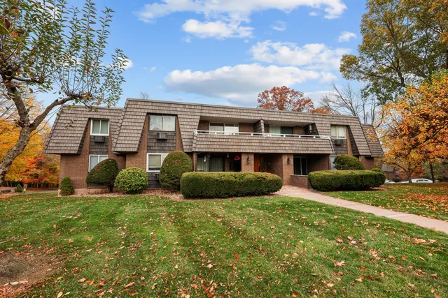 a view of a house with a yard and a garden