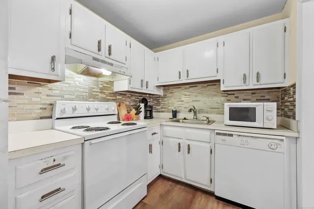 a kitchen with cabinets appliances and a sink
