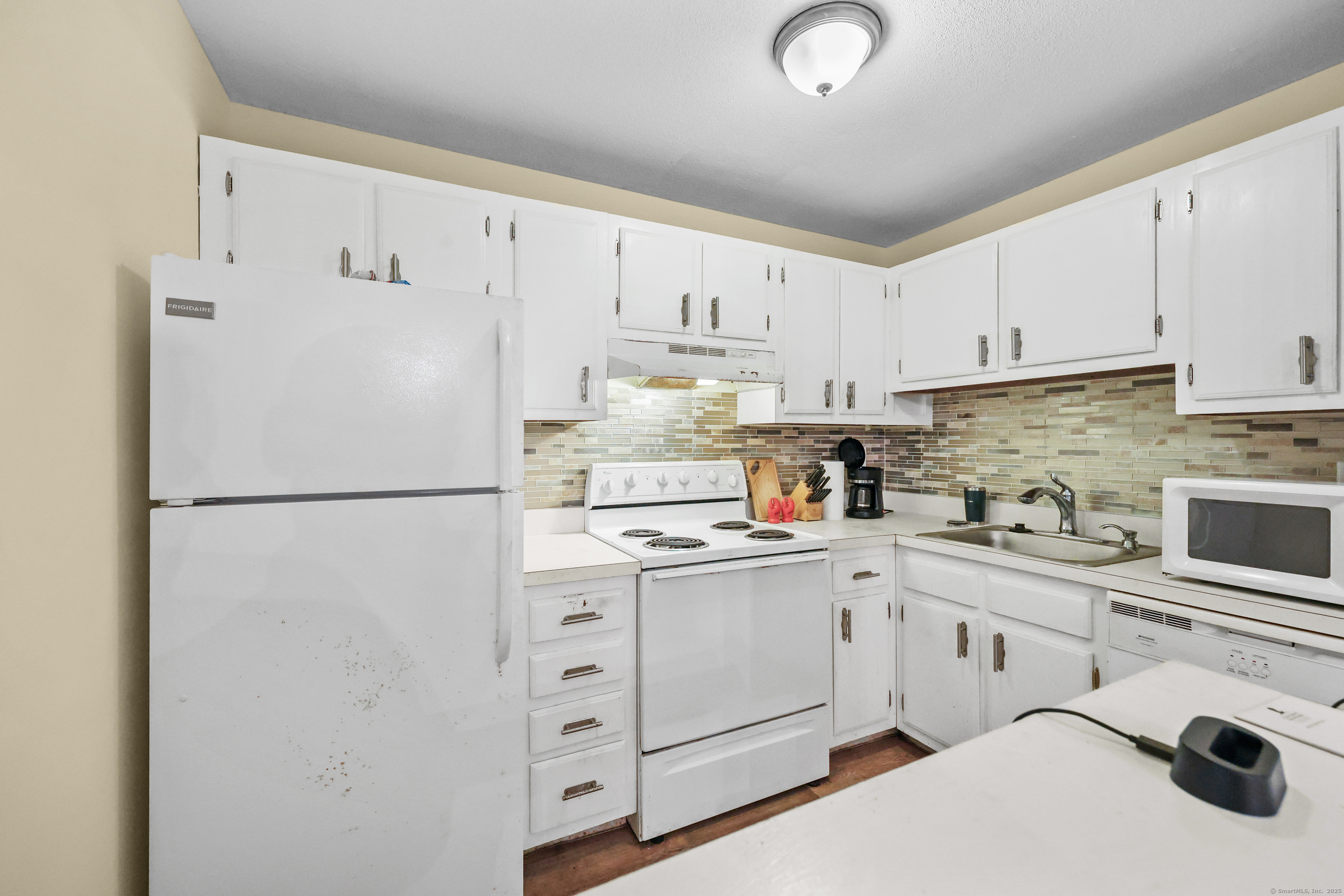 60 Rambling Brook Lane, Unit C8 Glastonbury, CT 06033 - Photo 8 of 20 a white refrigerator freezer sitting in a kitchen