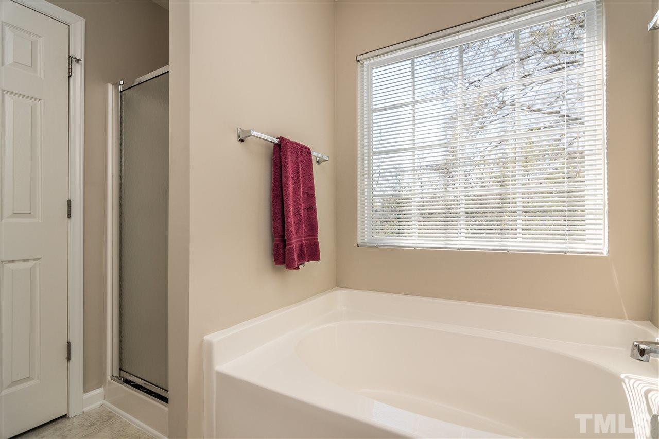 3786 Burtons Barn Street Raleigh, NC 27610 - Photo 17 of 23 a white bath tub sitting next to a window