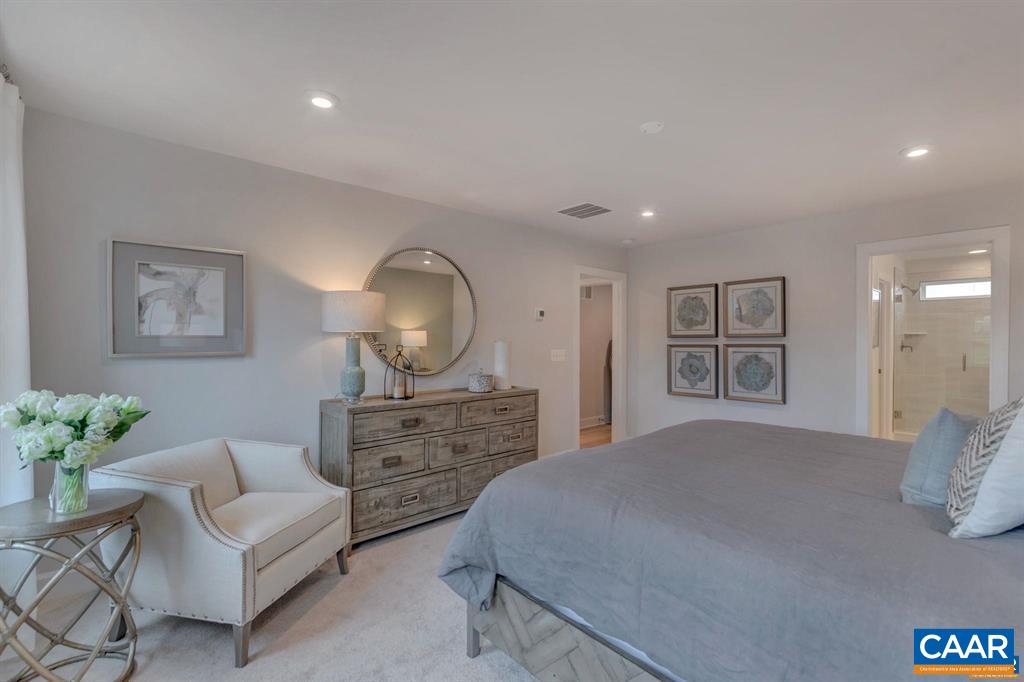 2837 Rambling Brook Lane Crozet, VA 22932 - Photo 18 of 24 a bedroom with a bed mirror and painting on the wall