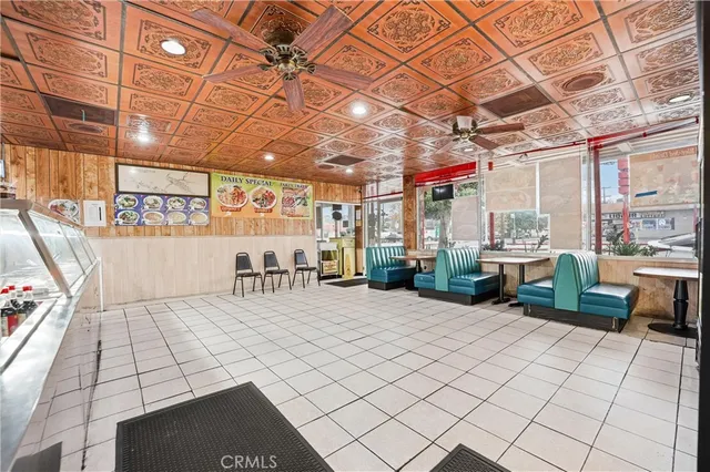 a large white kitchen with a stove a sink and a large window