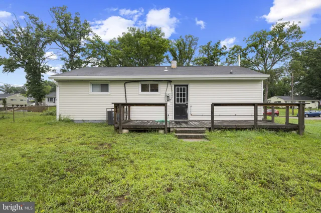 a backyard of a house with plants and a garden