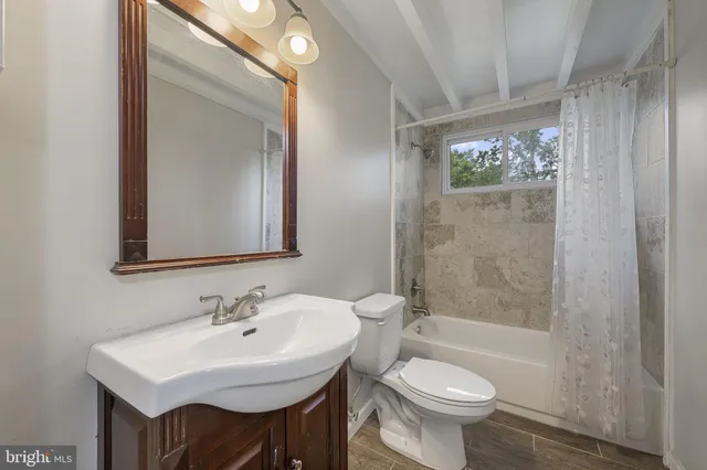 a bathroom with a sink toilet a mirror and shower