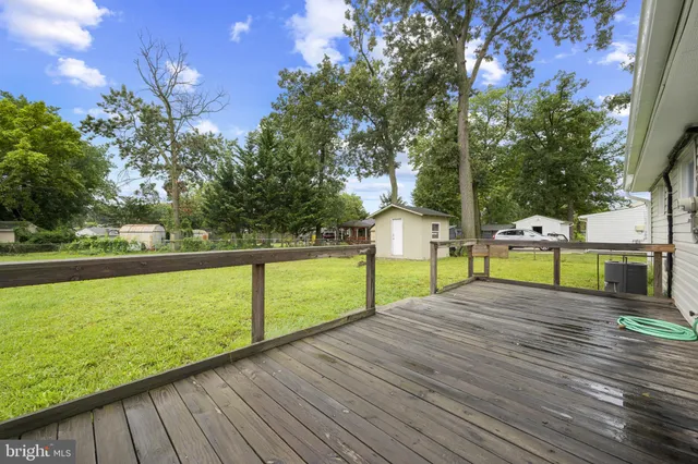 a view of a street with houses in back