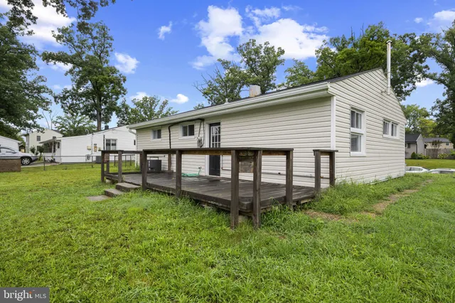 a view of a house with a yard and sitting area