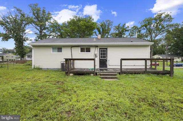 a backyard of a house with plants and a garden