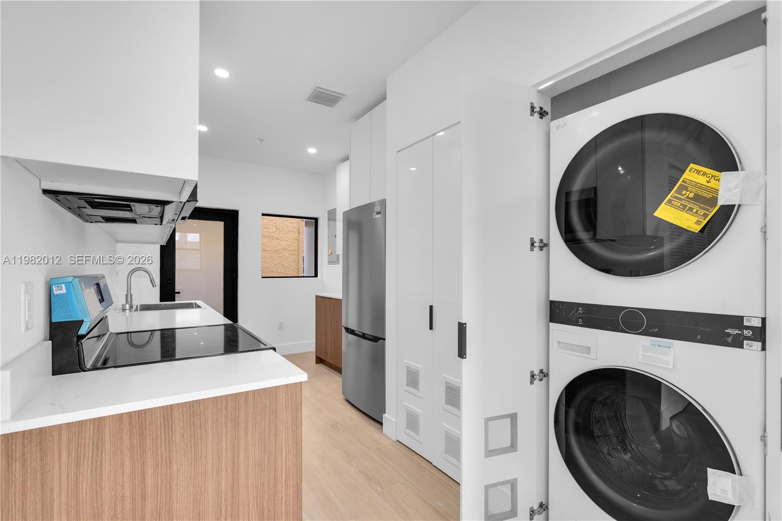 1037 Northwest 2nd Street, Unit 2B2 Miami, FL 33128 - Photo 4 of 15 a view of living room washer and dryer