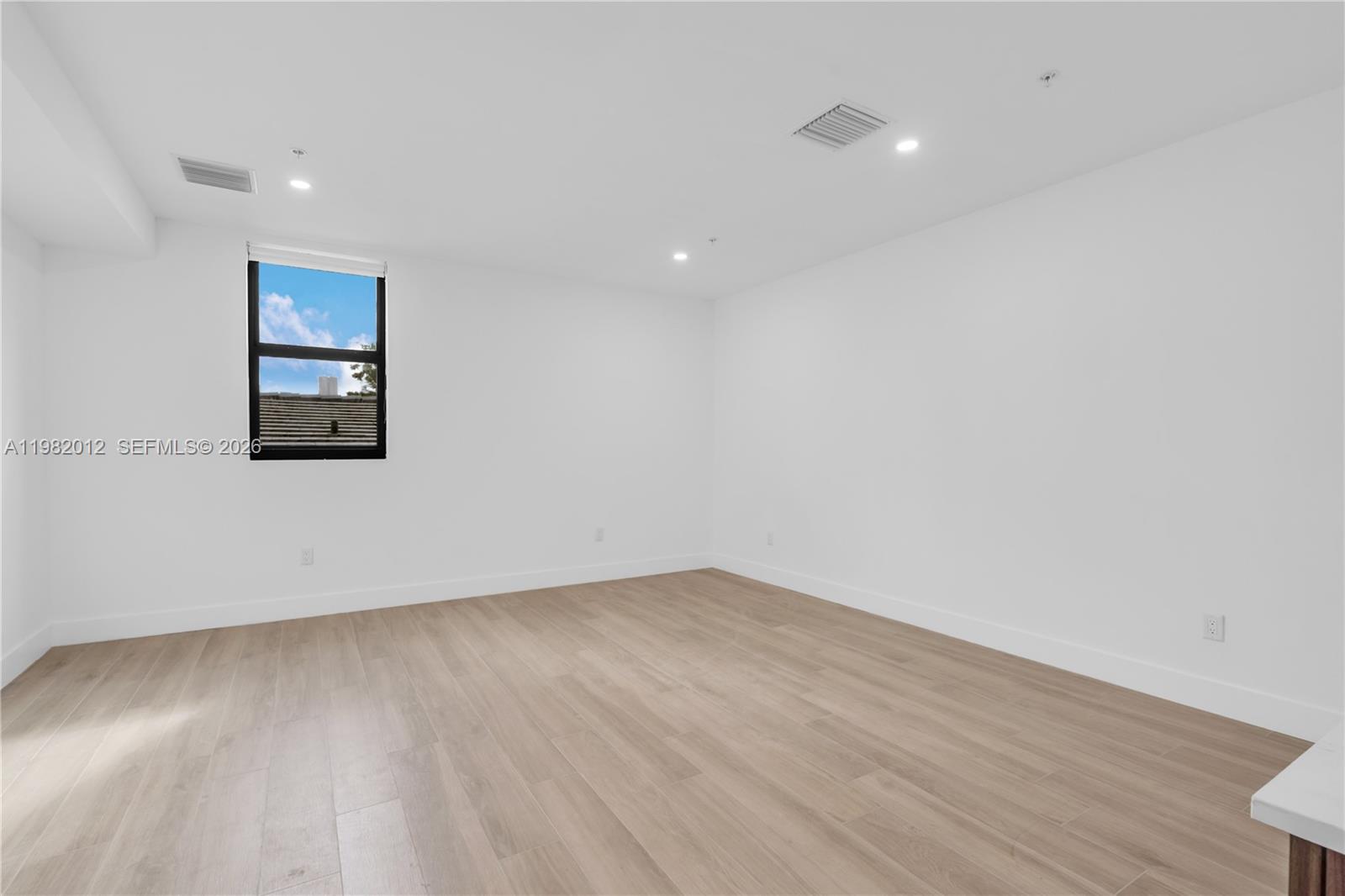 1037 Northwest 2nd Street, Unit 2B2 Miami, FL 33128 - Photo 5 of 15 an empty room with wooden floor and closet