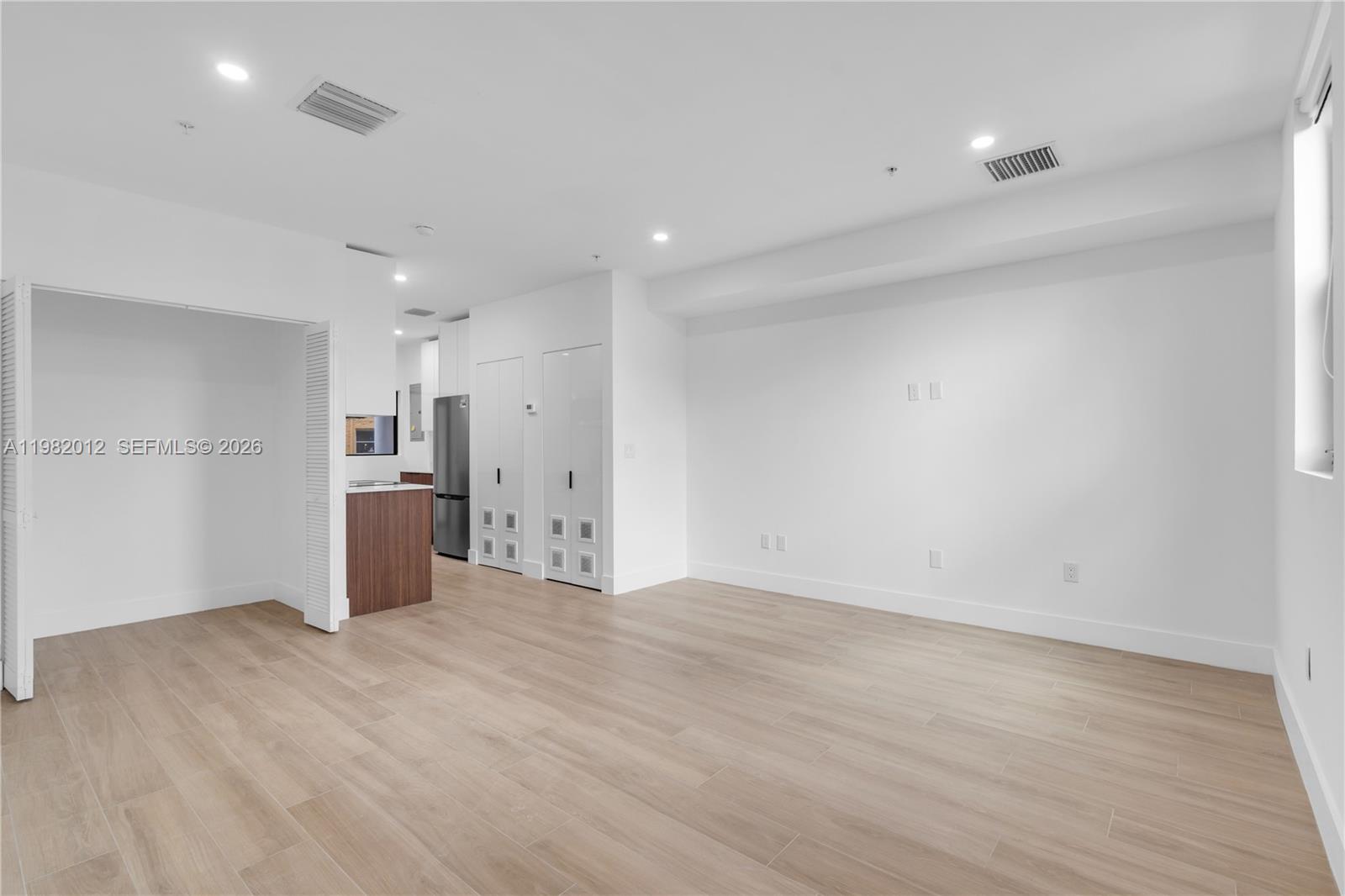 1037 Northwest 2nd Street, Unit 2B2 Miami, FL 33128 - Photo 6 of 15 a view of a kitchen with a sink and wooden floor