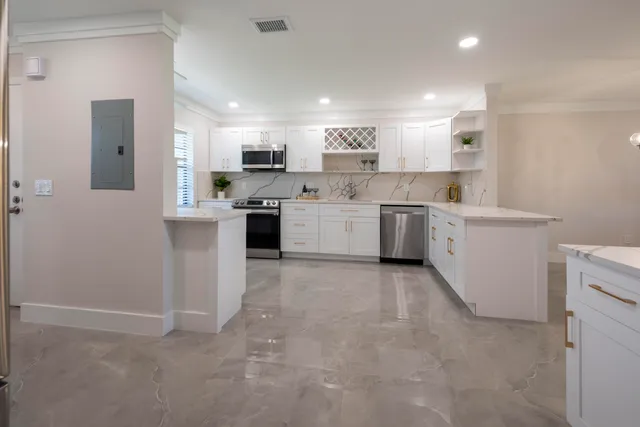 a large kitchen with cabinets and stainless steel appliances