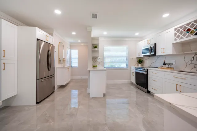 a kitchen with refrigerator and cabinets