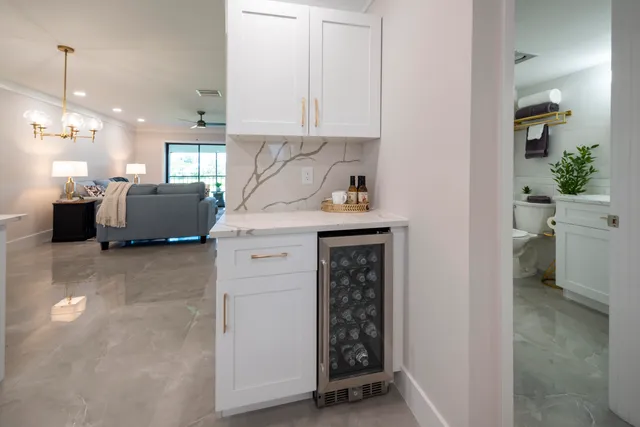a kitchen with white cabinets and white appliances