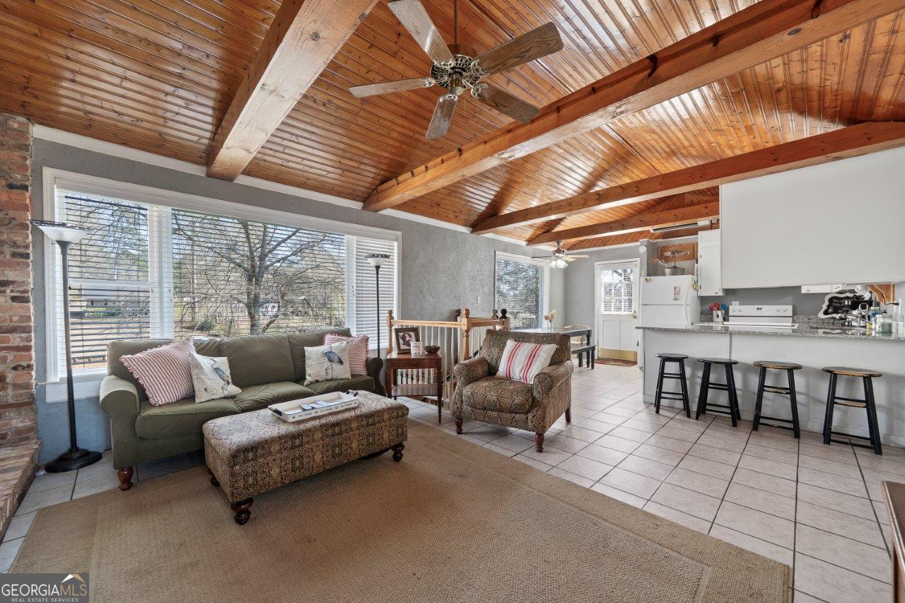 109 Horseshoe Bend Road Southwest Eatonton, GA 31024 - Photo 11 of 42 a living room with furniture and a large window