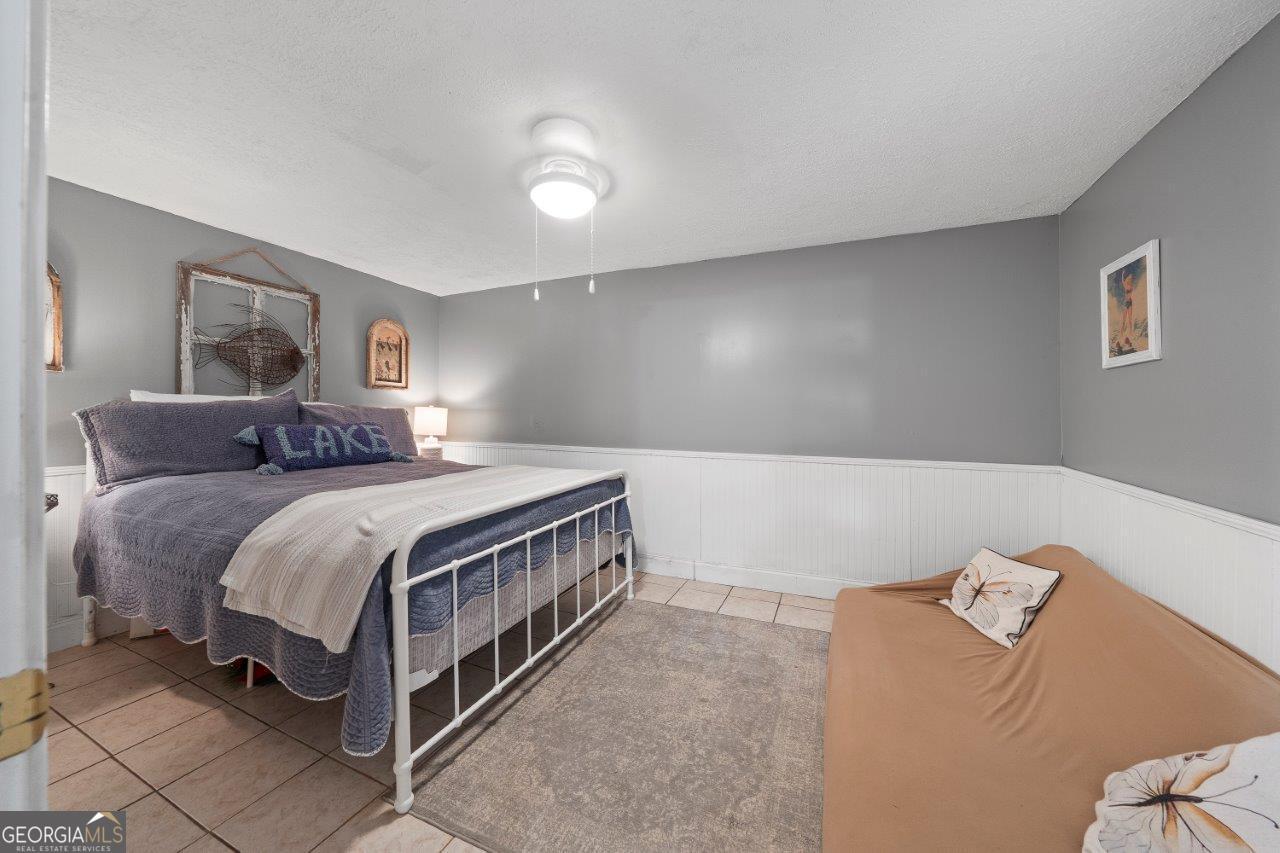 109 Horseshoe Bend Road Southwest Eatonton, GA 31024 - Photo 22 of 42 a bedroom with a bed and a couch