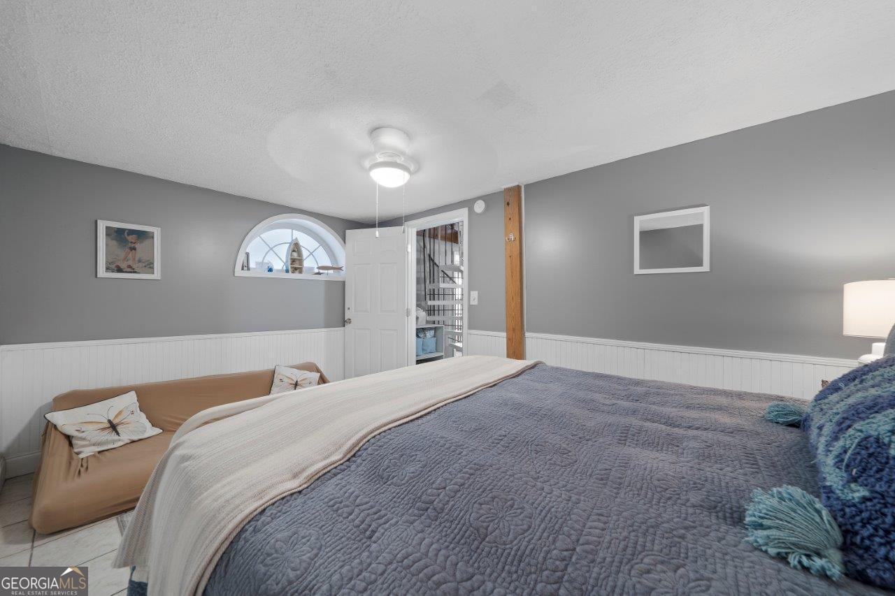109 Horseshoe Bend Road Southwest Eatonton, GA 31024 - Photo 23 of 42 a bedroom with a large bed and a window