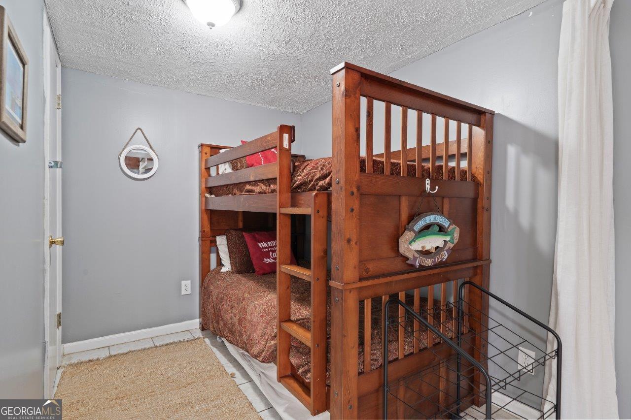 109 Horseshoe Bend Road Southwest Eatonton, GA 31024 - Photo 25 of 42 a bedroom with furniture and a window