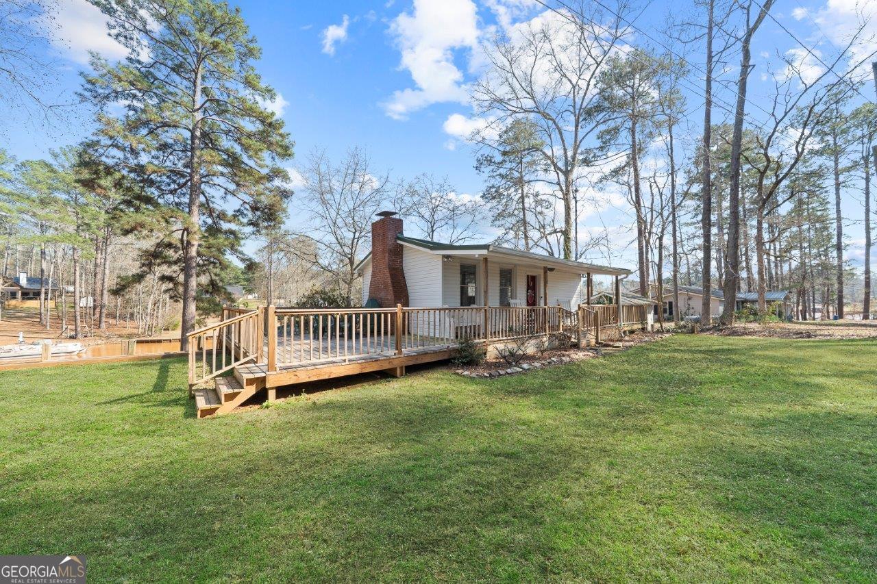 109 Horseshoe Bend Road Southwest Eatonton, GA 31024 - Photo 4 of 42 a view of a house with a yard porch and sitting area