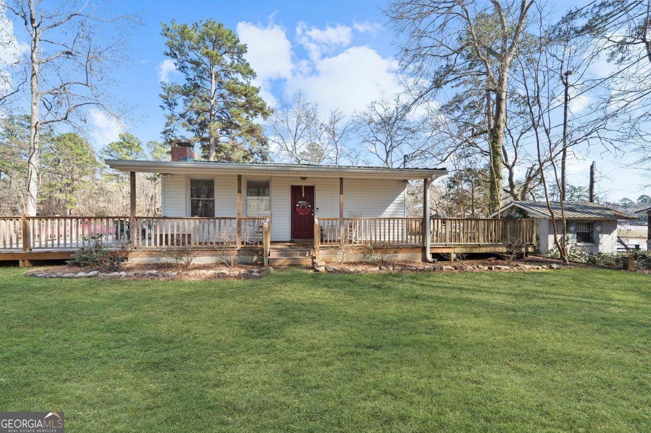 109 Horseshoe Bend Road Southwest Eatonton, GA 31024 - Photo 5 of 42 a view of a house with backyard and sitting area