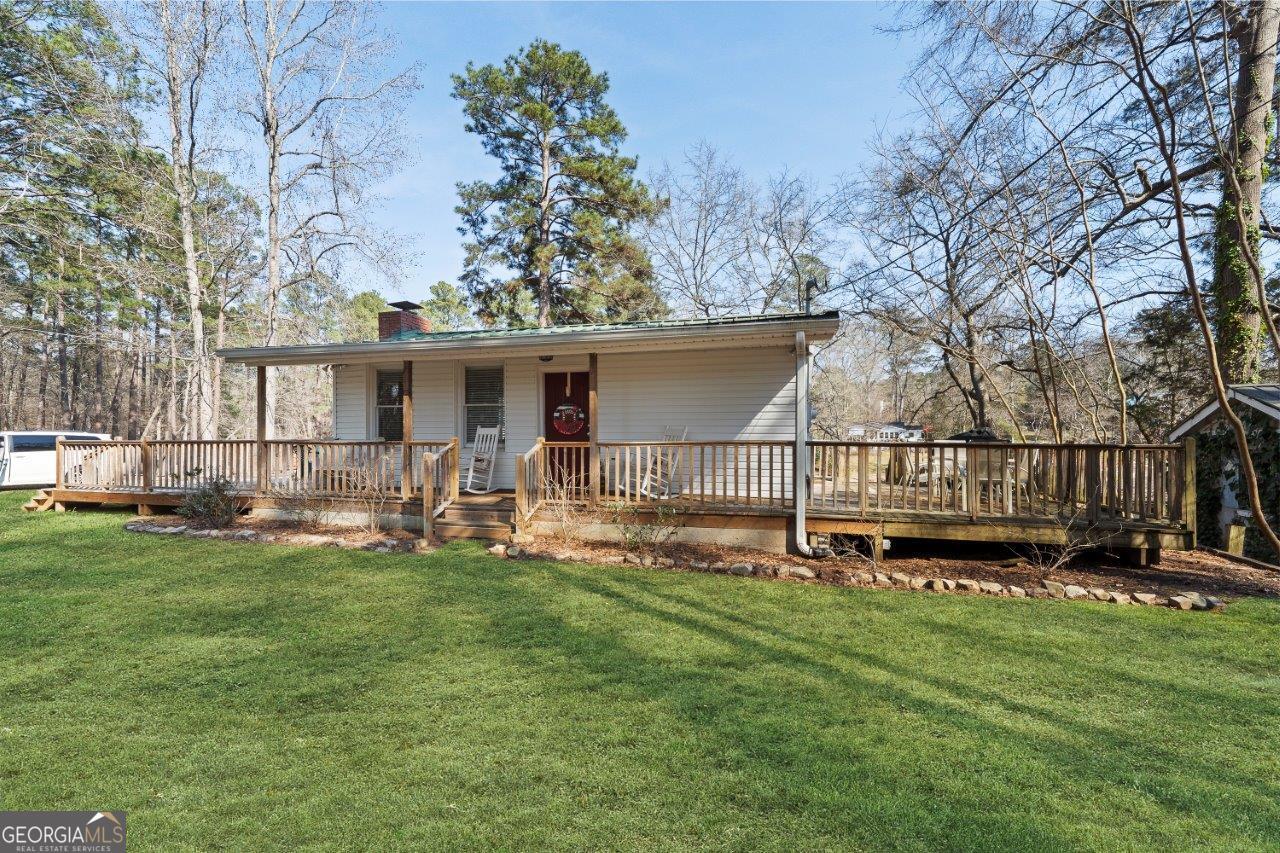 109 Horseshoe Bend Road Southwest Eatonton, GA 31024 - Photo 6 of 42 a view of a house with backyard and deck