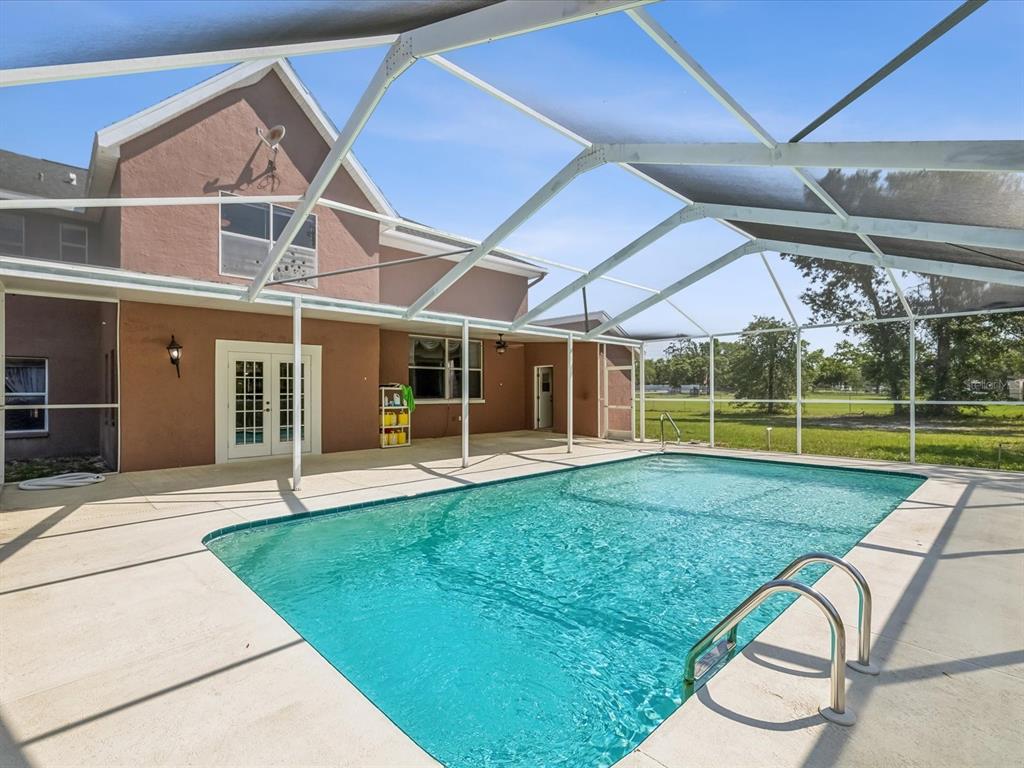 15420 Aubrey Avenue Spring Hill, FL 34610 - Photo 26 of 28 a view of a house with backyard and porch