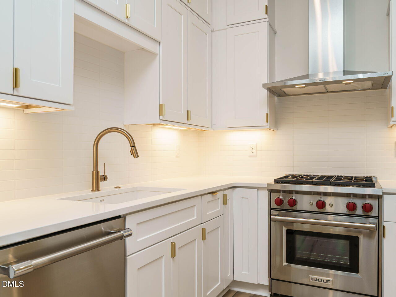 1533 Urban Trace Lane Raleigh, NC 27608 - Photo 14 of 28 a kitchen with a stove and a sink